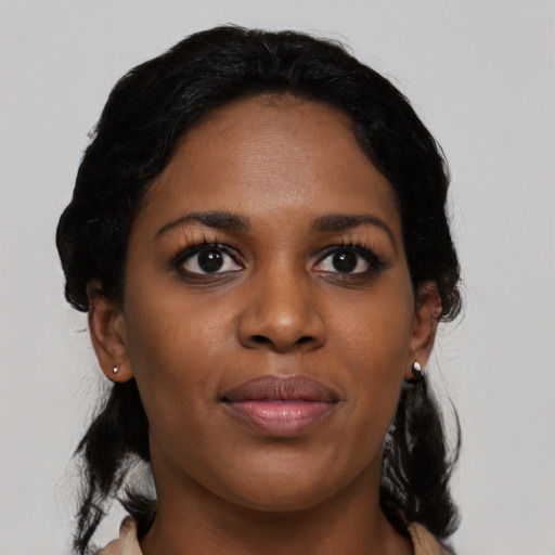 Joyful black young-adult female with medium  black hair and brown eyes