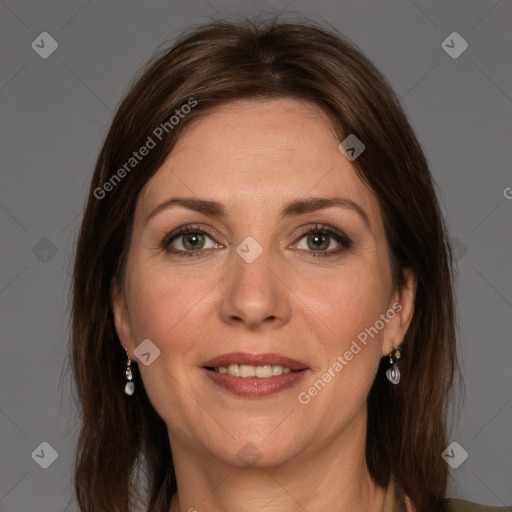 Joyful white adult female with long  brown hair and grey eyes