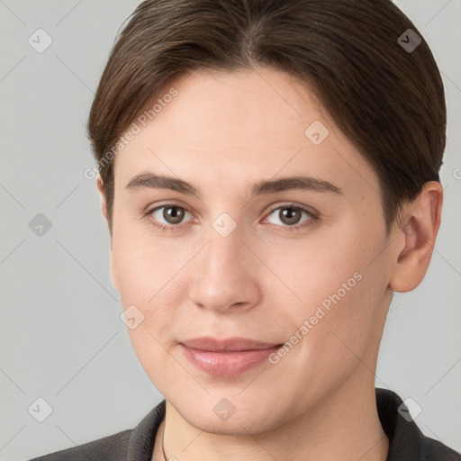 Joyful white young-adult female with short  brown hair and grey eyes