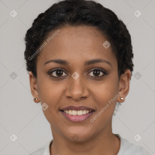 Joyful black young-adult female with short  black hair and brown eyes