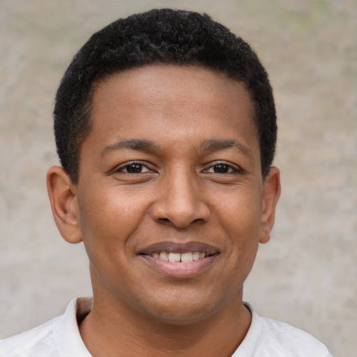 Joyful black young-adult male with short  brown hair and brown eyes