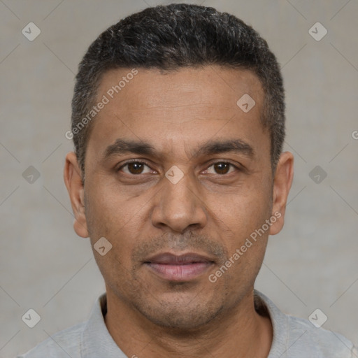 Joyful white adult male with short  black hair and brown eyes