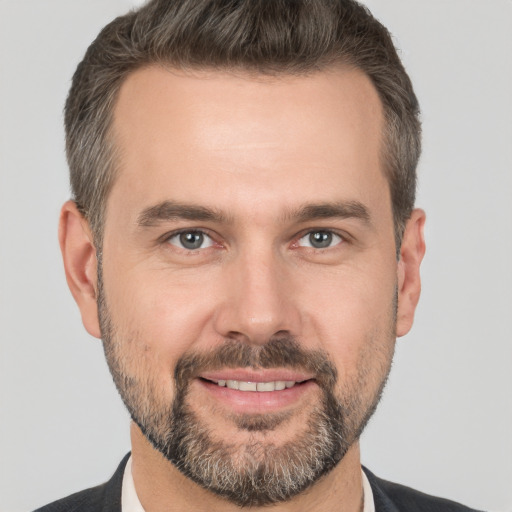 Joyful white adult male with short  brown hair and brown eyes