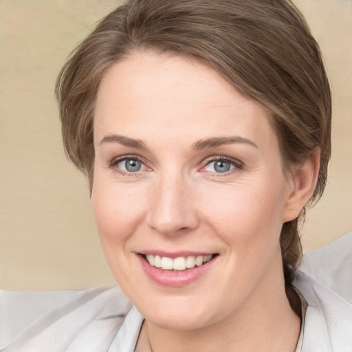 Joyful white adult female with medium  brown hair and grey eyes