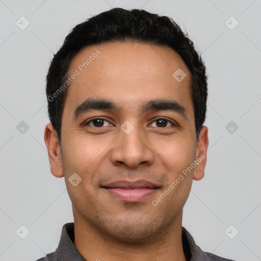 Joyful latino young-adult male with short  black hair and brown eyes