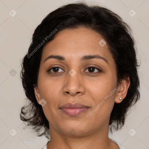 Joyful latino adult female with medium  brown hair and brown eyes