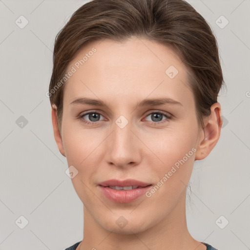 Joyful white young-adult female with short  brown hair and grey eyes