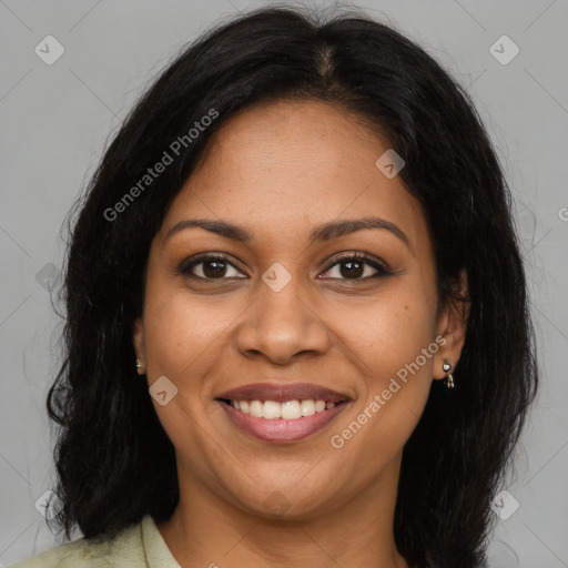 Joyful black adult female with long  brown hair and brown eyes