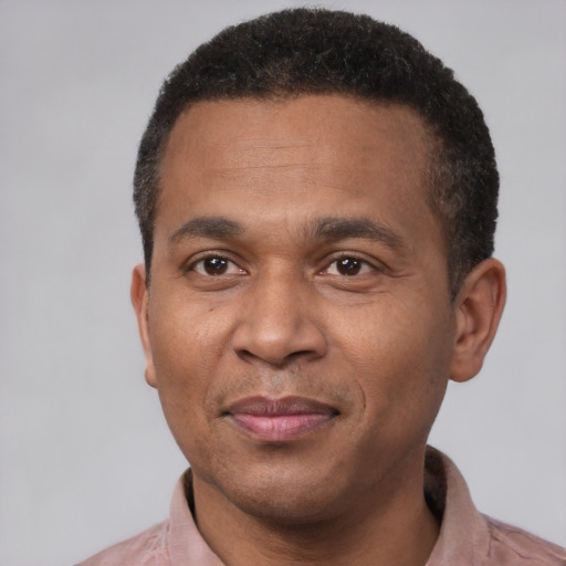 Joyful latino adult male with short  black hair and brown eyes