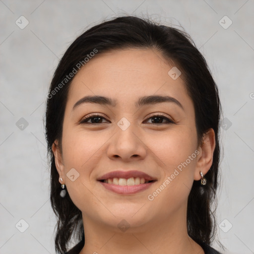 Joyful latino young-adult female with medium  brown hair and brown eyes