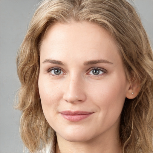 Joyful white young-adult female with long  brown hair and blue eyes