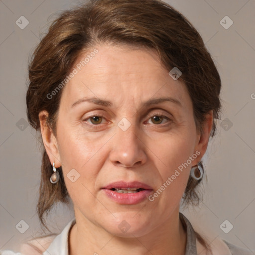 Joyful white adult female with medium  brown hair and grey eyes