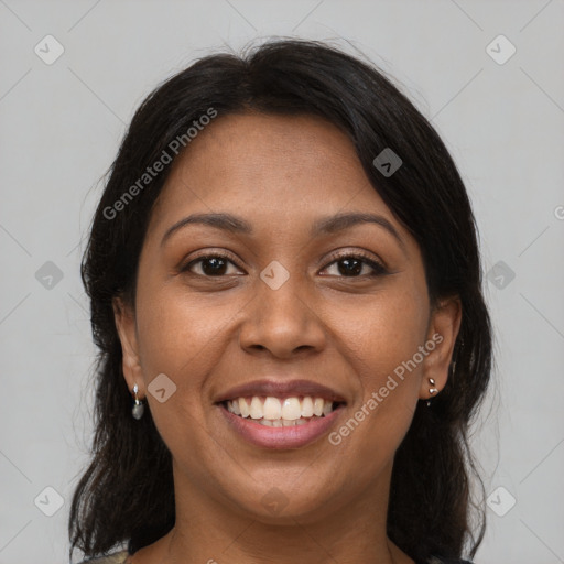 Joyful black young-adult female with long  brown hair and brown eyes