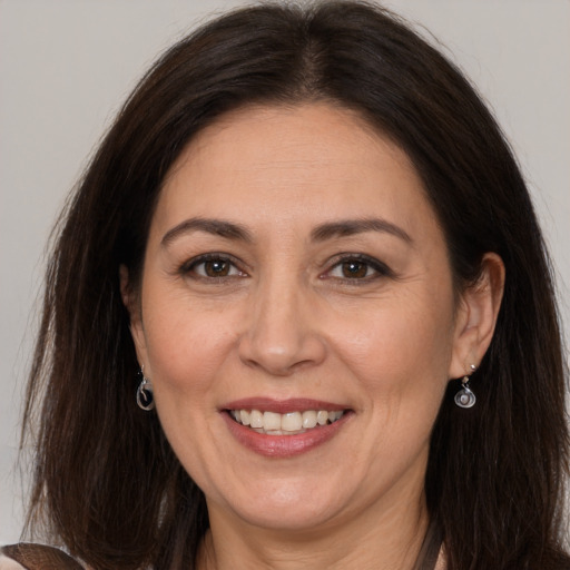 Joyful white adult female with long  brown hair and brown eyes