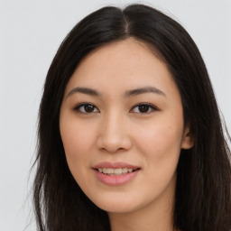 Joyful asian young-adult female with long  brown hair and brown eyes