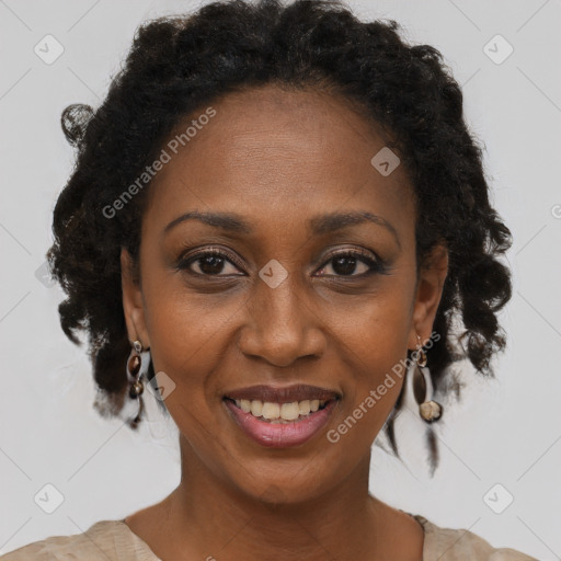 Joyful black adult female with medium  brown hair and brown eyes