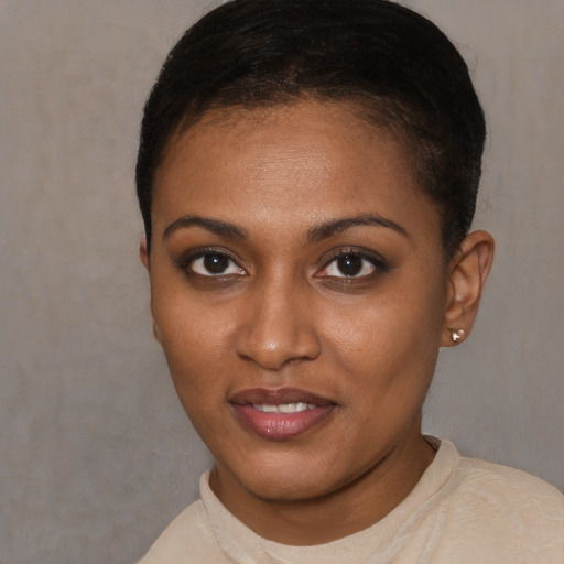 Joyful black young-adult female with short  brown hair and brown eyes