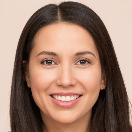 Joyful white young-adult female with long  brown hair and brown eyes