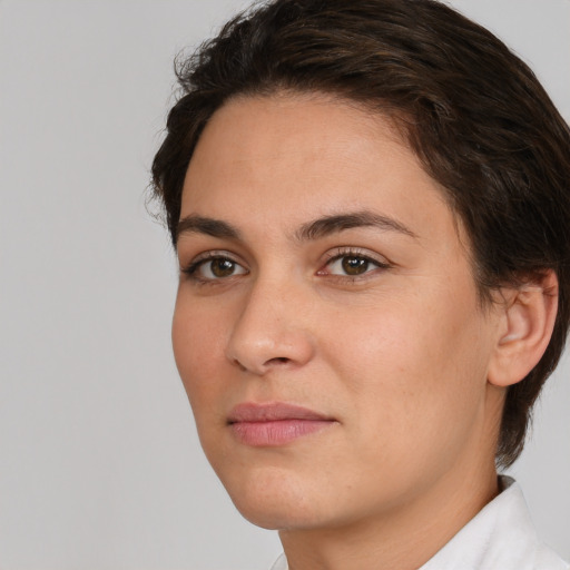 Joyful white young-adult female with short  brown hair and brown eyes