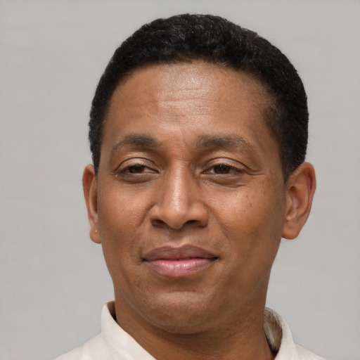 Joyful latino adult male with short  brown hair and brown eyes