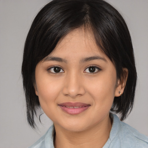 Joyful asian young-adult female with medium  brown hair and brown eyes