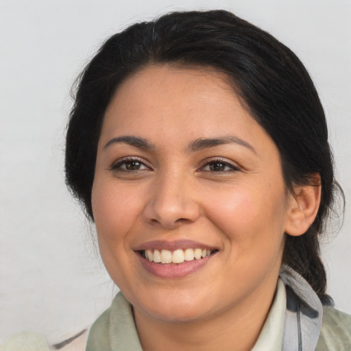 Joyful latino young-adult female with medium  brown hair and brown eyes