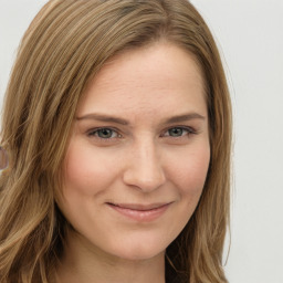 Joyful white young-adult female with long  brown hair and green eyes