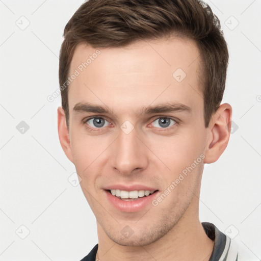 Joyful white young-adult male with short  brown hair and grey eyes