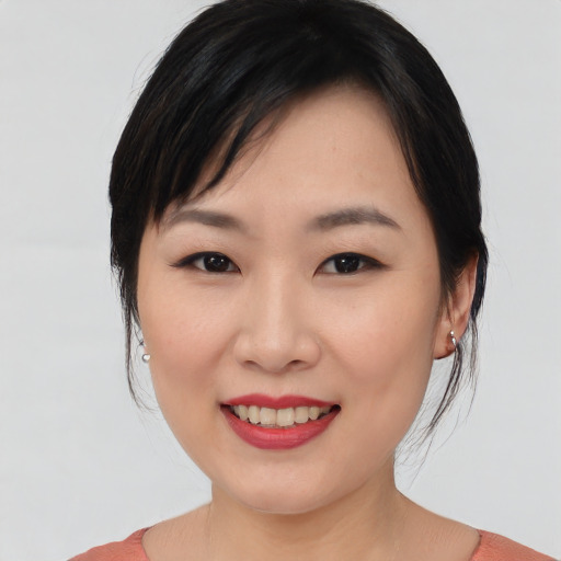 Joyful asian young-adult female with medium  black hair and brown eyes