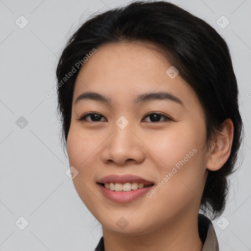 Joyful asian young-adult female with medium  black hair and brown eyes