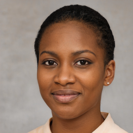 Joyful black young-adult female with short  black hair and brown eyes