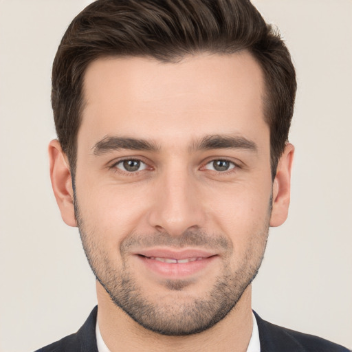 Joyful white young-adult male with short  brown hair and brown eyes