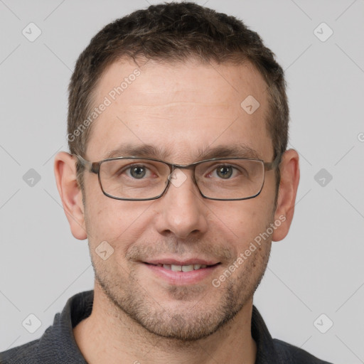 Joyful white adult male with short  brown hair and grey eyes