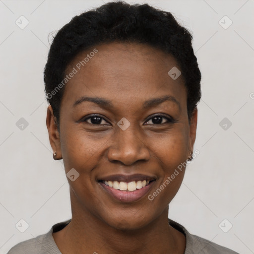 Joyful black young-adult female with short  black hair and brown eyes