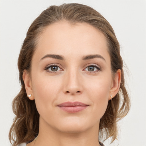 Joyful white young-adult female with medium  brown hair and grey eyes