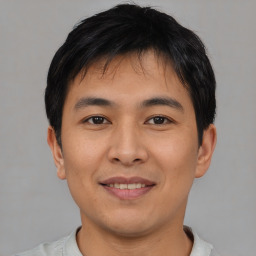 Joyful asian young-adult male with short  black hair and brown eyes