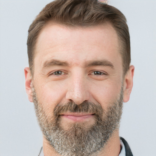 Joyful white adult male with short  brown hair and brown eyes