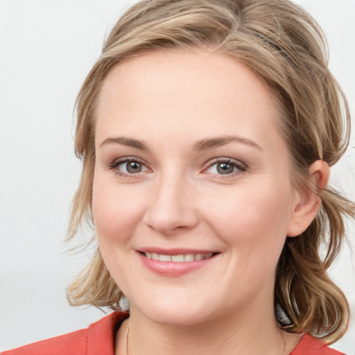 Joyful white young-adult female with medium  brown hair and blue eyes