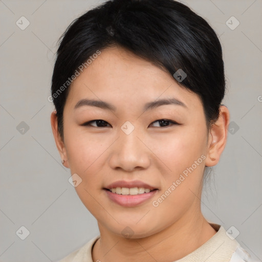 Joyful asian young-adult female with short  black hair and brown eyes