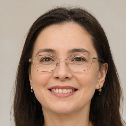 Joyful white adult female with long  brown hair and brown eyes