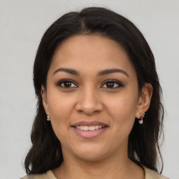 Joyful latino young-adult female with medium  brown hair and brown eyes