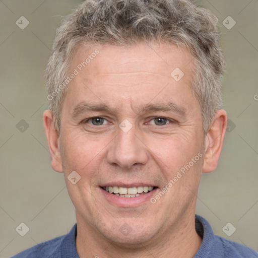 Joyful white adult male with short  brown hair and grey eyes