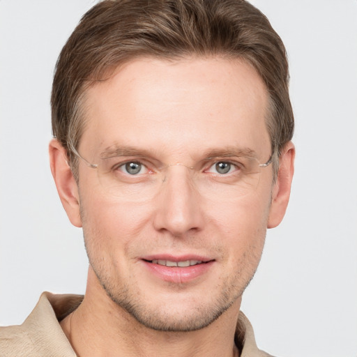 Joyful white adult male with short  brown hair and grey eyes