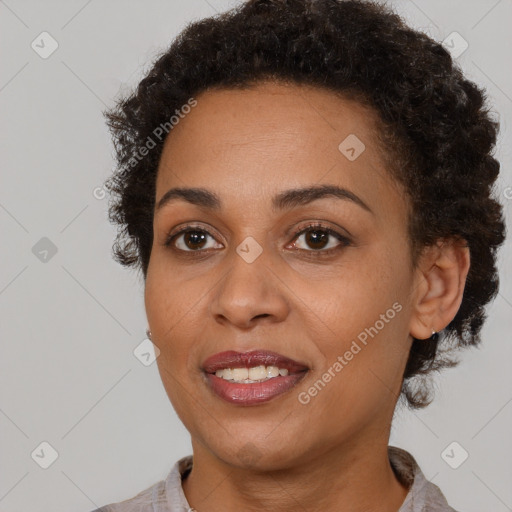 Joyful black young-adult female with short  brown hair and brown eyes