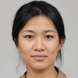 Joyful asian young-adult female with medium  black hair and brown eyes