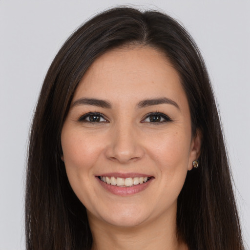 Joyful white young-adult female with long  brown hair and brown eyes