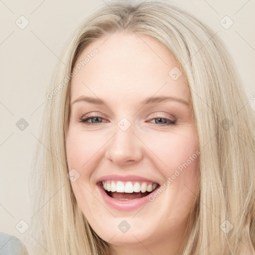 Joyful white young-adult female with long  brown hair and blue eyes