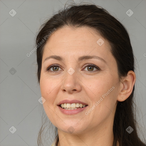 Joyful white adult female with long  brown hair and brown eyes