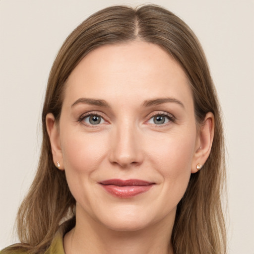 Joyful white young-adult female with long  brown hair and grey eyes