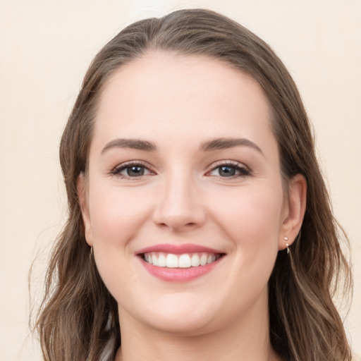 Joyful white young-adult female with long  brown hair and grey eyes